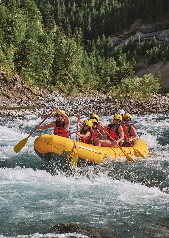 A group of people paddling in white water.