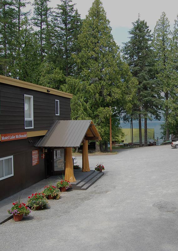 Front of motel exterior, with lake in the background.