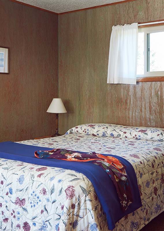 a bed and a lamp in a hotel room