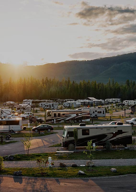RV Park full with a sunburst above the hill range behind it.