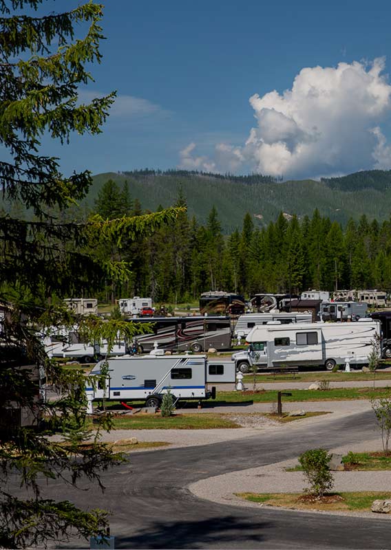View of the West Glacier RV Park from above; RVs fill the grassy sites