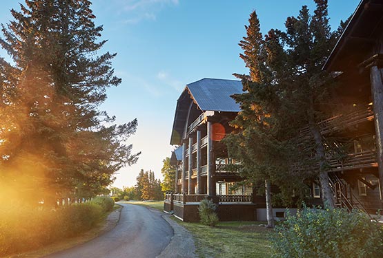 Sun shines against the historic Glacier Park Lodge