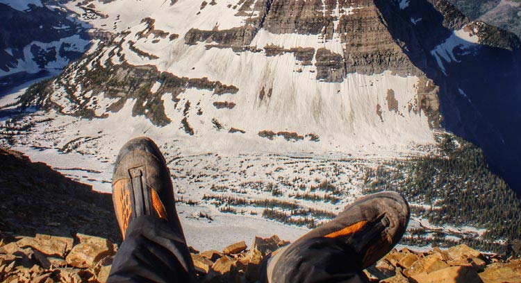 Hiking boots with a mountain backdrop