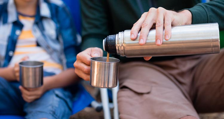 A cup of coffee poured from a thermos.