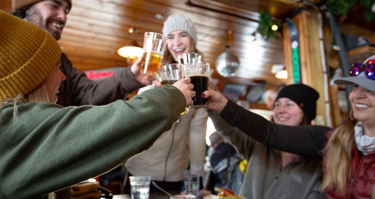 Five friends raise glasses of beer in a cheers