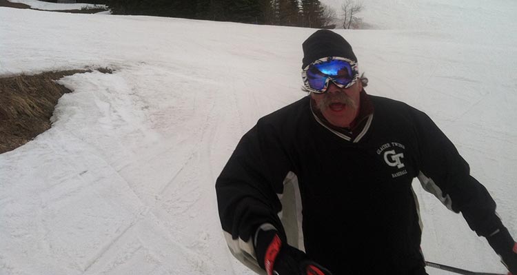 A man skiing down a snowy mountain slope.