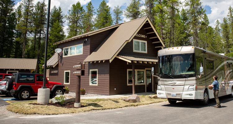 An RV stopped at the entrance to the West Glacier RV Park