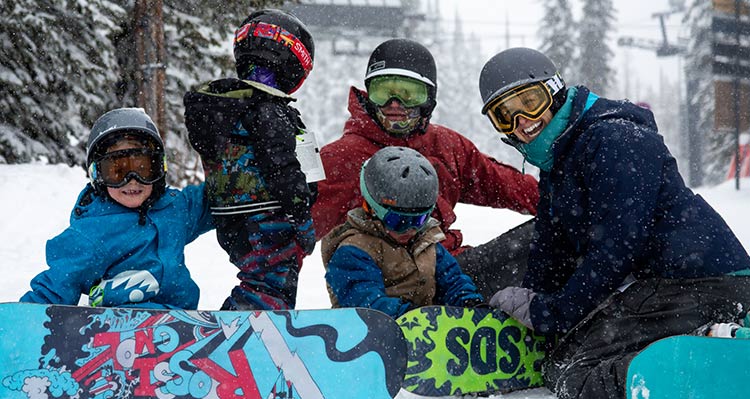 A family takes a break on a ski hill