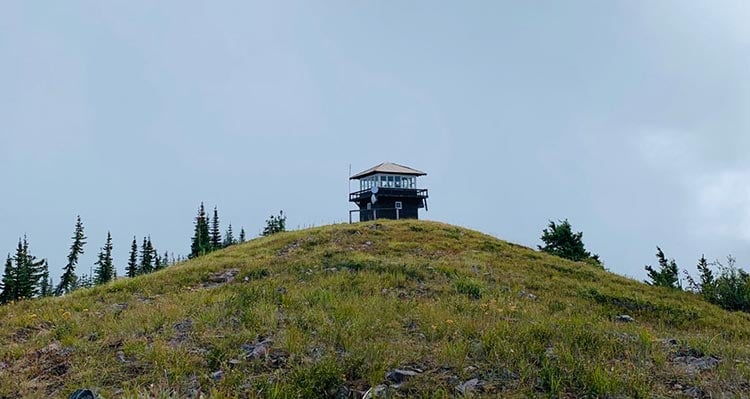 A lookout tower atop a hill.