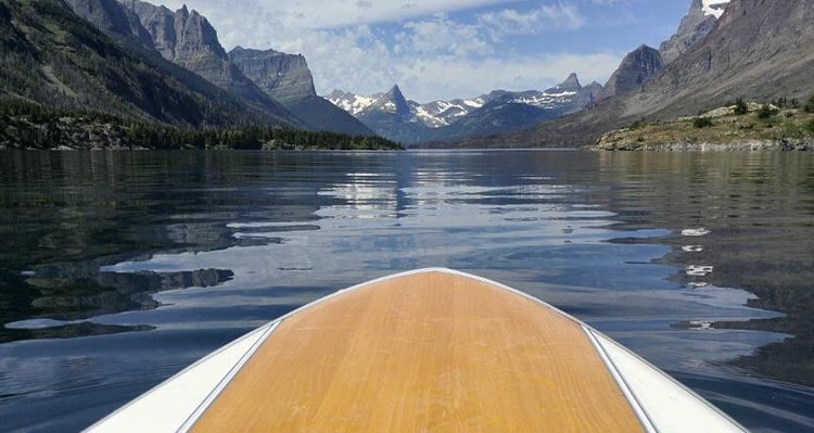 A view of Saint Mary Lake from the bow of a boat