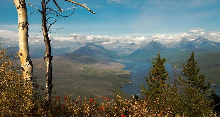 A view across a large lake and tree-covered valleys.