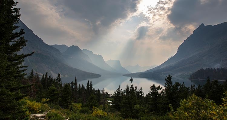 Sun shines through the clouds on St. Mary Lake