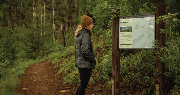 Woman Reading Trail Map