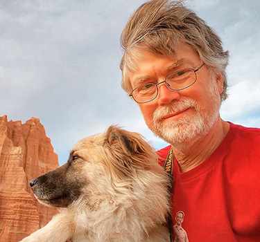 John Ashley holds his dog