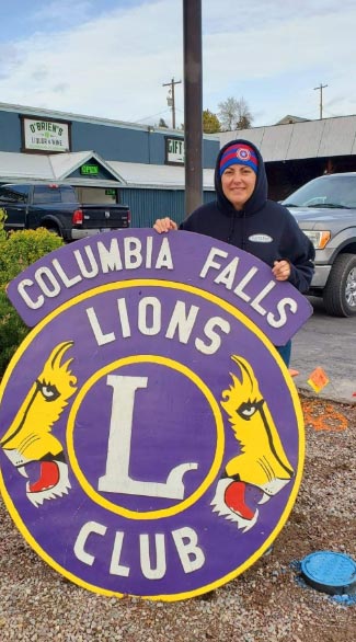 A woman sets up a sign.