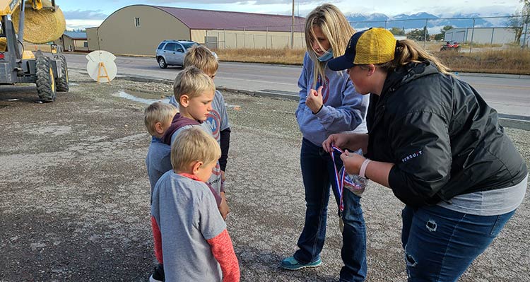 Medals are presented to a group of children.