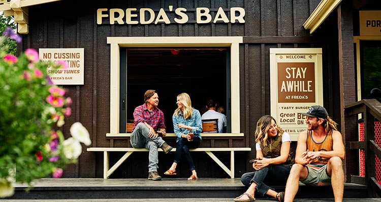 Two couples sit outside of the wood restaurant.