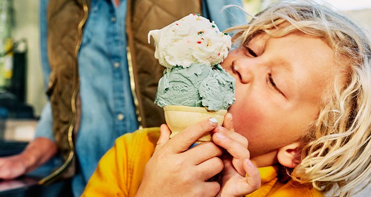 A child eating an ice cream cone.