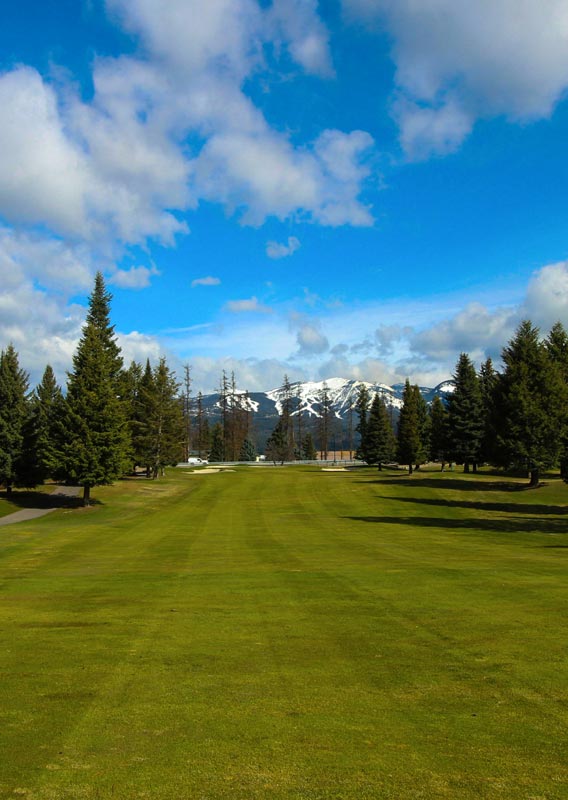 Man swinging golf club at East Glacier