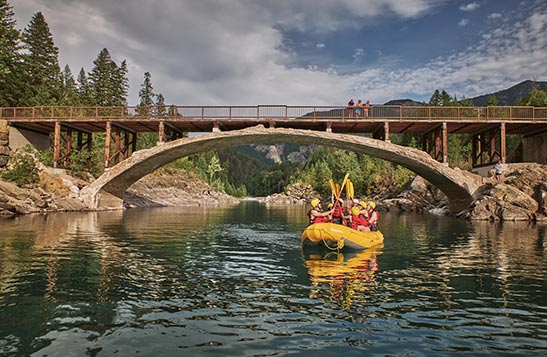 A group of rafters under a bridge