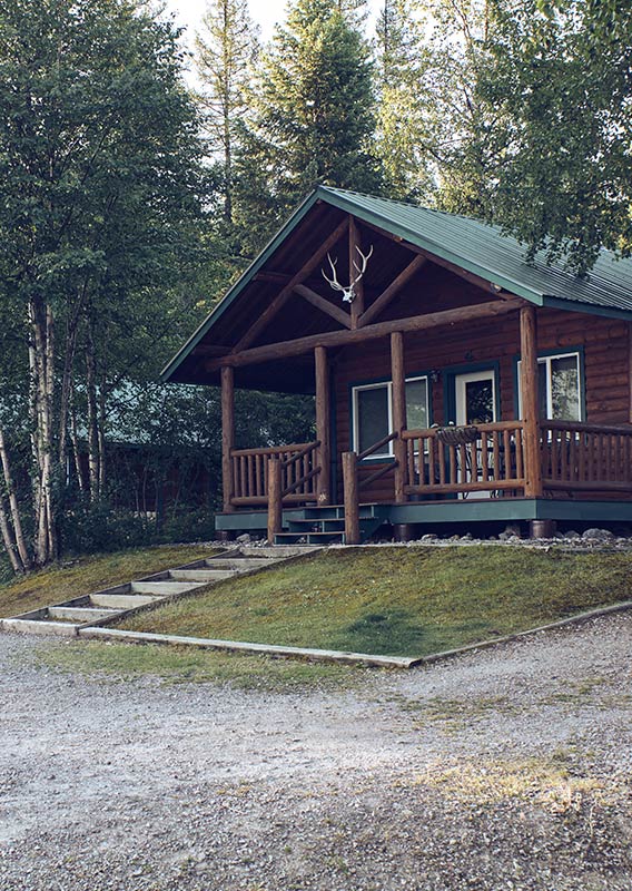 Exterior of a wooden cabin in the summer.