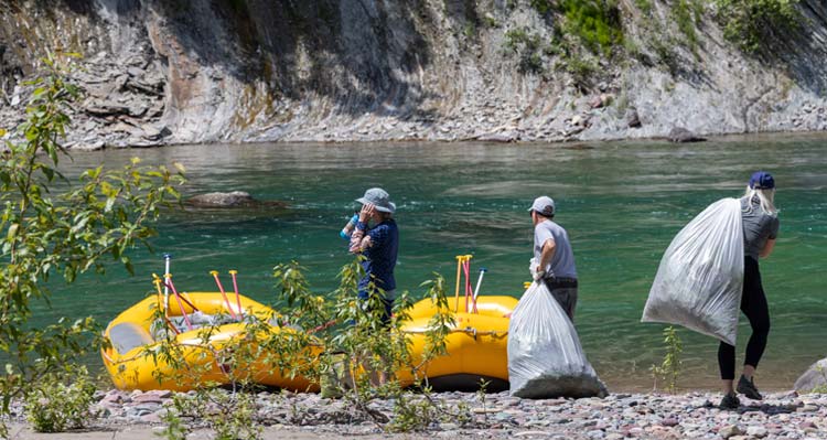 People cleaning up the shorline by the river