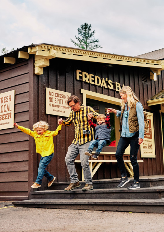 A family walking down the steps at Freda's Bar