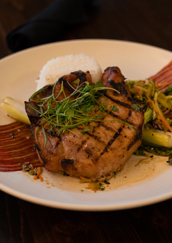 A steak dinner presented with rice and vegetables