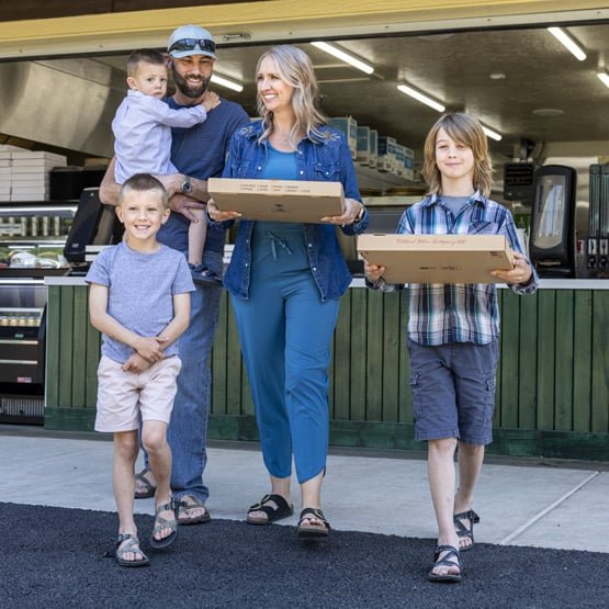Family taking pizzas to go from Glacier National Pizza