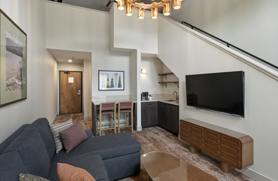 An interior view of a hotel room living room.