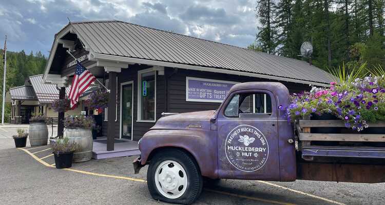 Huckleberry Hut vintage purple truck parked in front of the gift shop