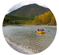 A rafting group floating down a scenic part of the Flathead River.