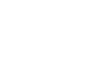 A couple walking down a path at the Belton Chalet