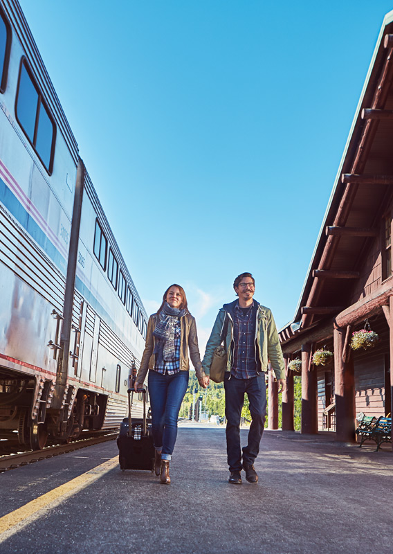 Two people walking along the train platform