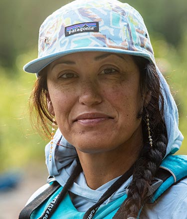 A portrait of a woman wearing a cap.