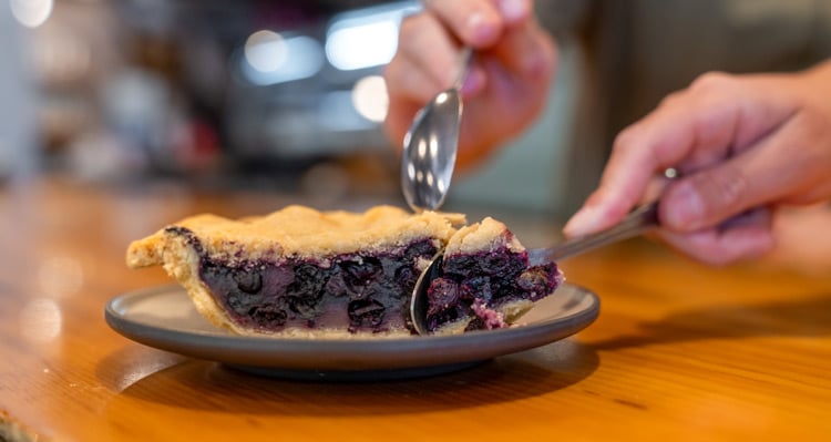 People digging into a slice of blueberry pie at Eddie's Cafe