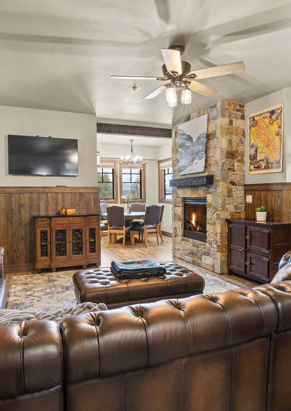The living room in a rental suite with large leather sofas.