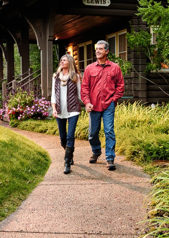 A couple walking down a path at the Belton Chalet