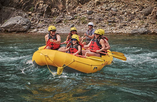 A group of people rafting on the water