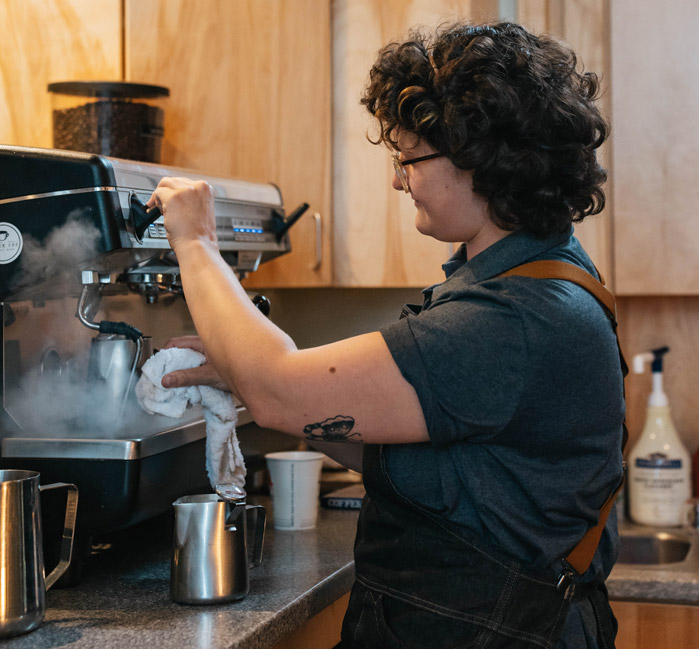 Barista making a coffee at the Princess Gift Shop and Cafe.