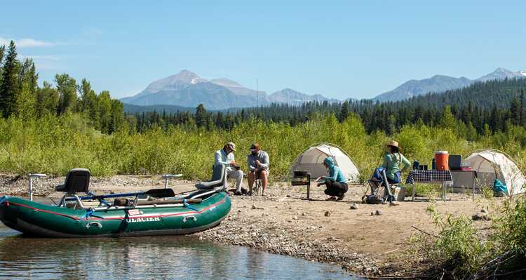 A group of people camped out on the shoreline