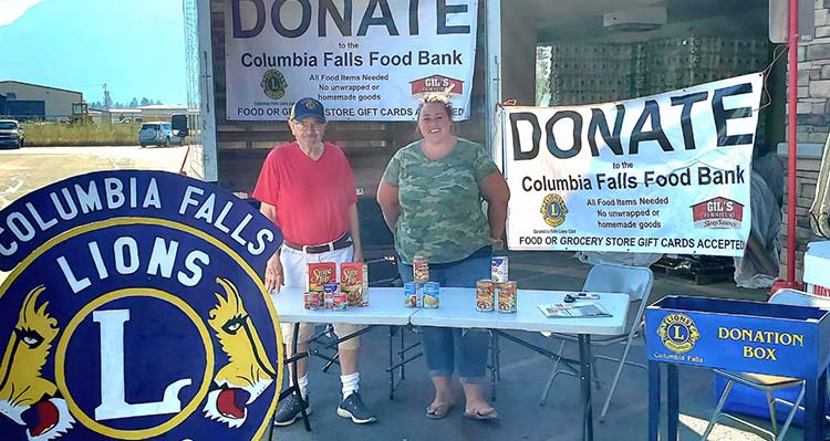 Columbia Falls Lions Club volunteers work a Food Bank donation table.