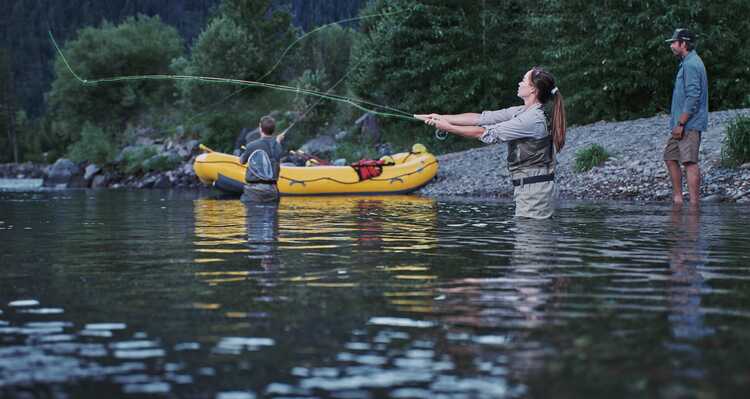 Group of people fly fishing in the river