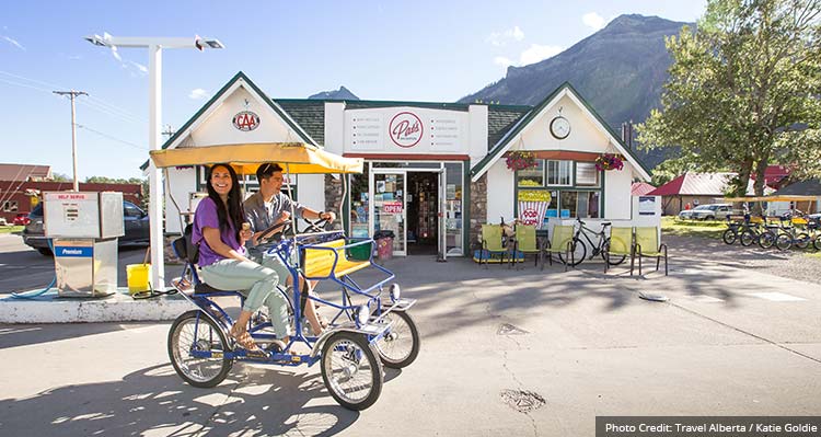 A man and woman in a bike buggy.