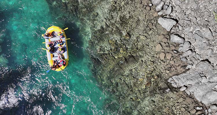 People on a river raft from above.