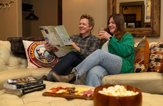 A couple relaxing in their hotel suite