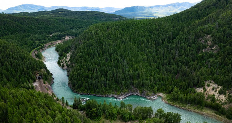 An aerial view of the Flathead River and surrounding mountains in West Glacier, Montana.
