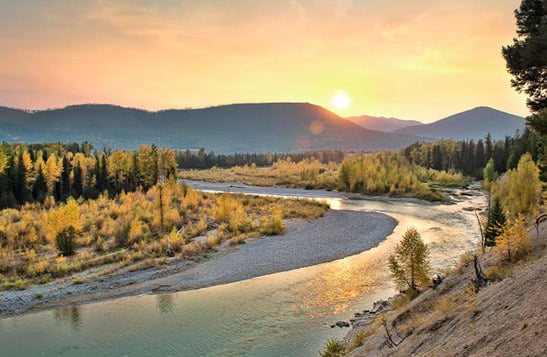 The Flathead River with a mountain view at sunset