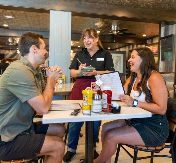 A couple talking with the Server at Eddie's Cafe