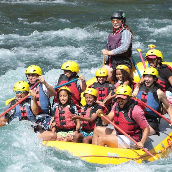 A rafting group paddling through rapids along the Flathead River.